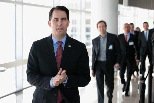 Wisconsin Gov. Scott Walker signs into law sweeping bills stripping powers from the Democrats