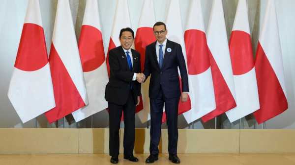 Japan’s leader holds security, business talks in Poland on his way to NATO summit
