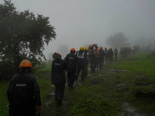 Indian rescuers recover 27 dead but no sign of dozens of missing villagers swamped by a landslide