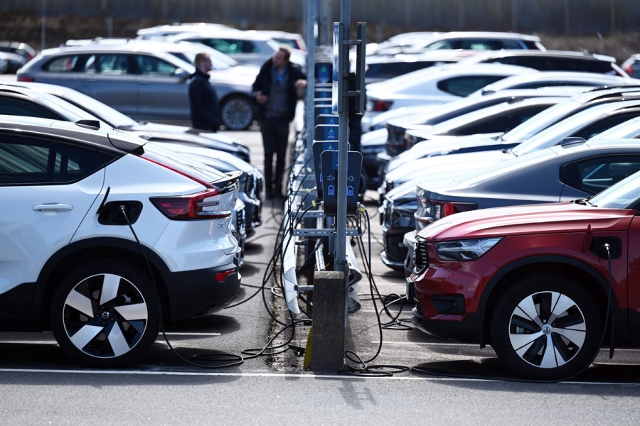 Electric vehicles charging in a parking lot in Sweden.