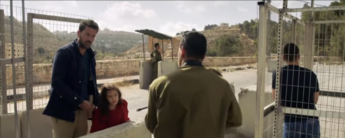 a man and a little girl trying to pass through a security checkpoint