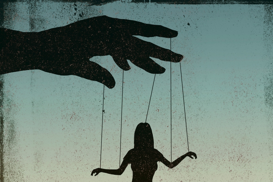 An illustration shows a silhouetted figure being controlled by strings connected to a puppeteer’s hand.