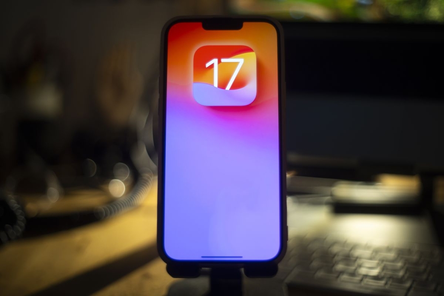 A photo of an iPhone showing the iOS 17 logo.