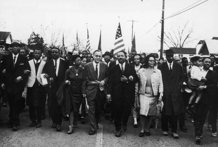 The kings lead marchers in a black-and-white photo.