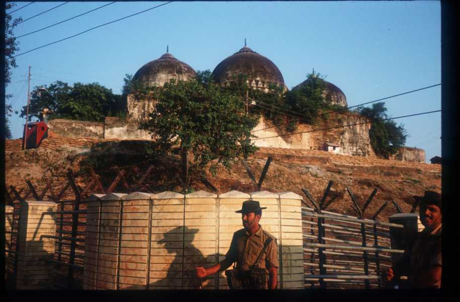 mosque on a hill guarded by fence.