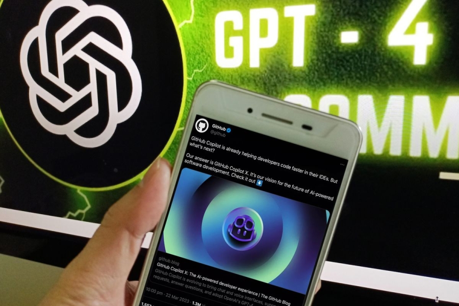 A hand holding a phone in front of a screen with the OpenAI logo and the term GPT-4.