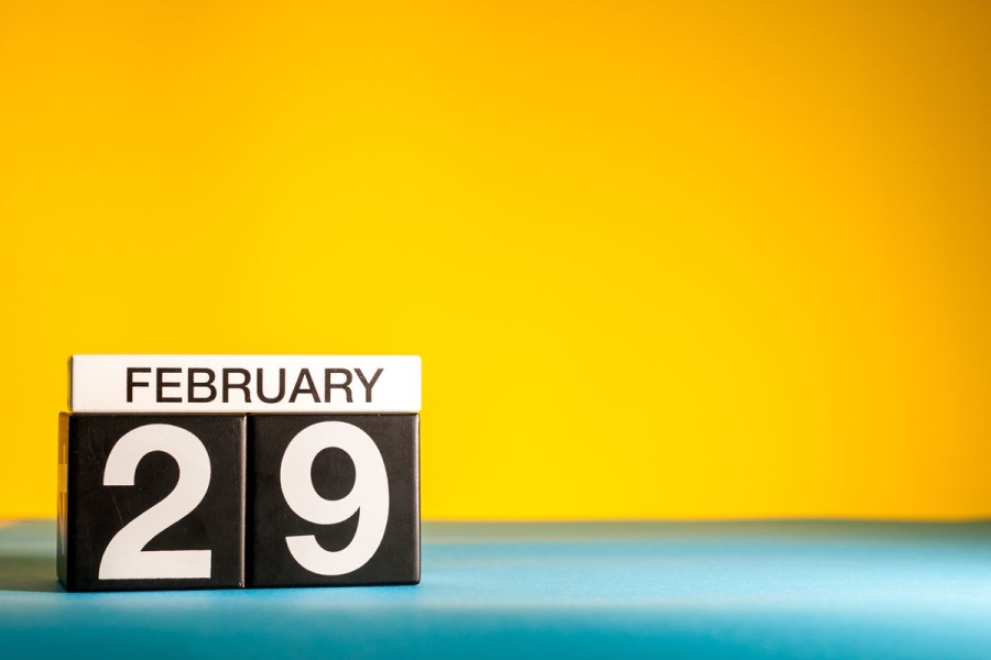 A calendar block date says February 29 in front of a yellow background.