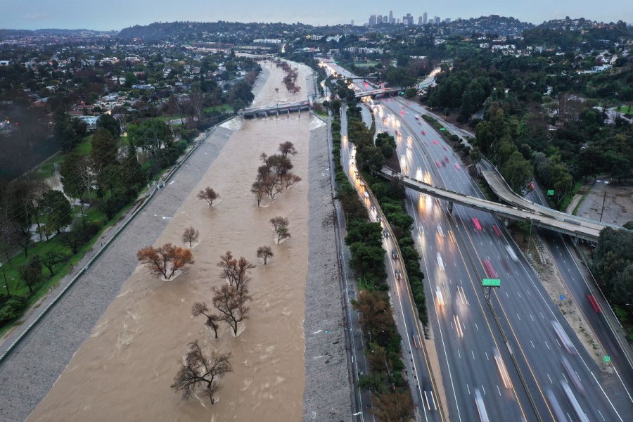 An aerial view of the Los Angeles River swollen by storm runoff as a powerful long-duration atmospheric river storm, the second in less than a week, continues to impact southern California on February 5, 2024, in Los Angeles.