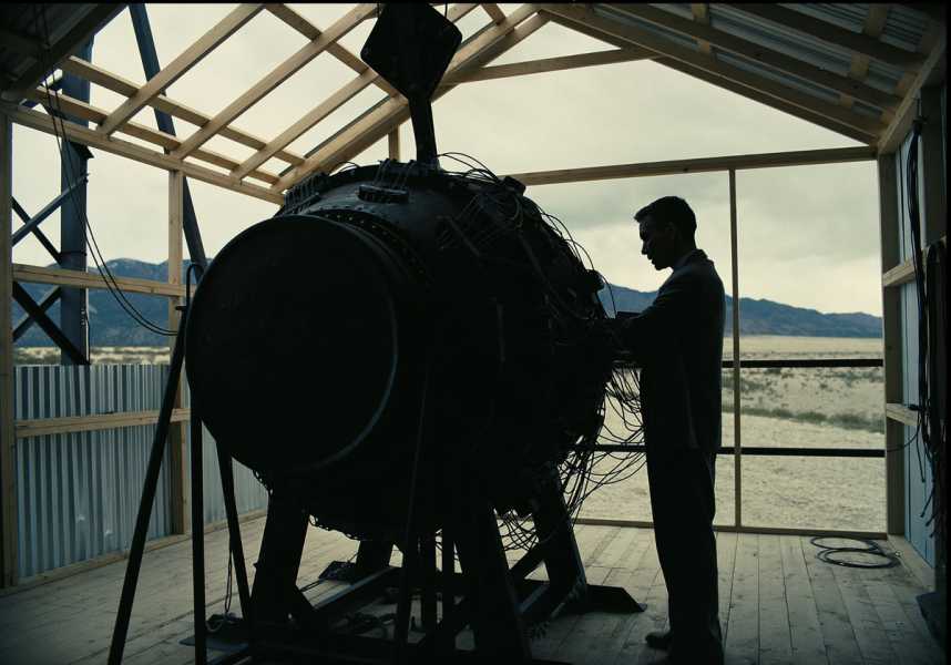 The silhouette of a man working on the atomic bomb.