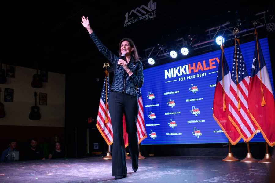 Presidential candidate Nikki Haley onstage waving to supporters.