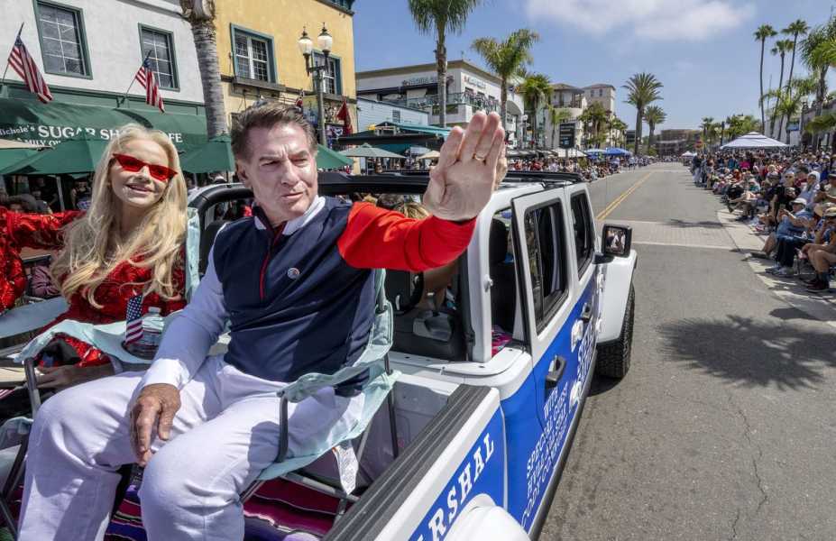 Steve Garvey waves to a crowd as he rides on a float during an Independence Day parade in Huntington Beach, California, in 2023.