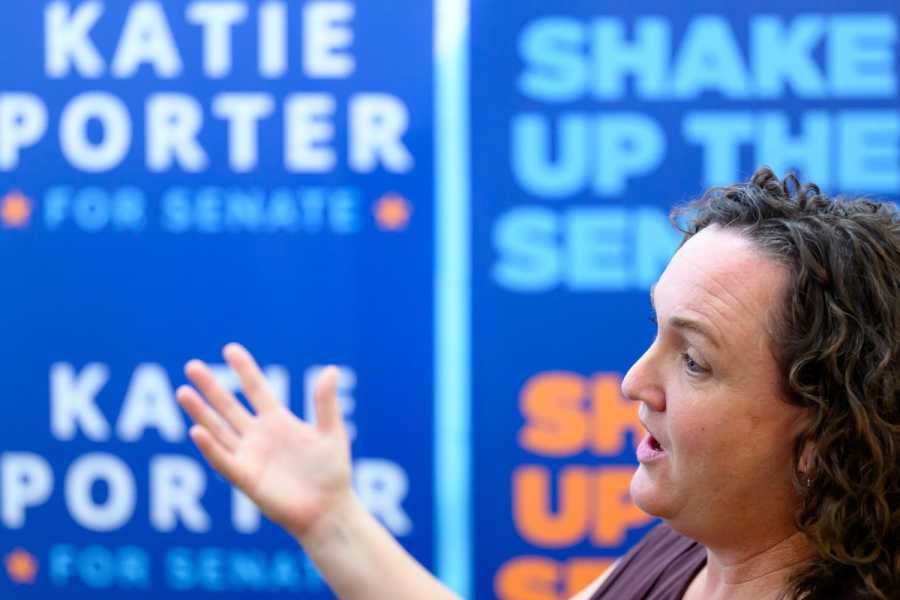 Senate candidate Katie Porter speaks in front of signs that read “Shape up the Senate” and “Katie Porter for Senate.”