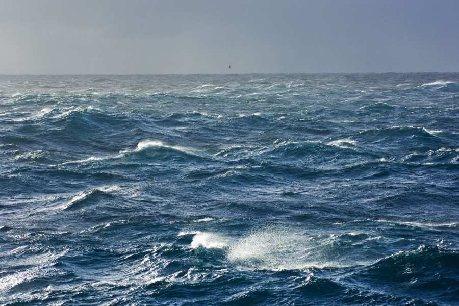 A photo of the ocean surface with choppy waves.