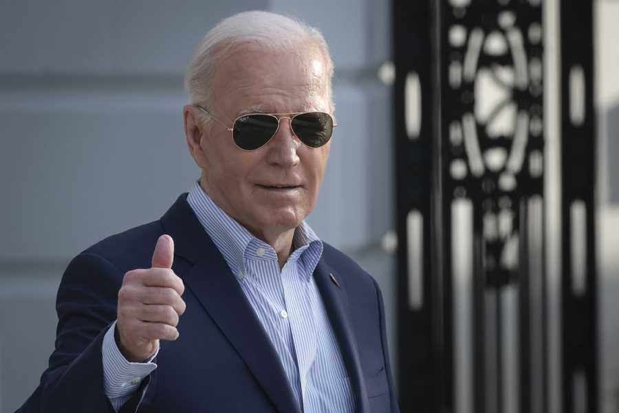 Biden, wearing sunglasses, gives a thumbs-up.