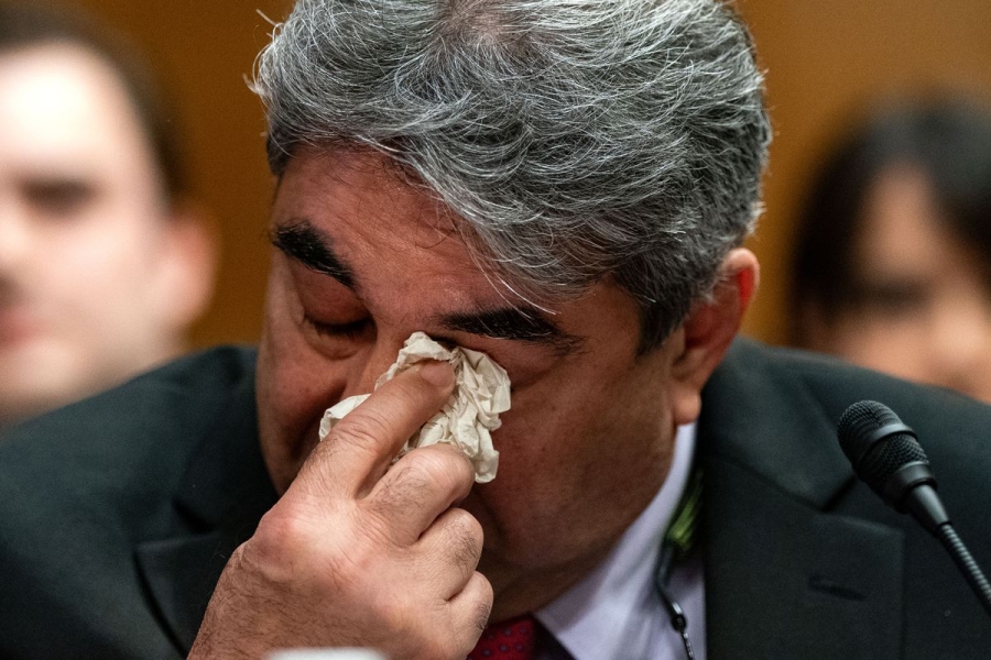 A close-up on Salehpour wiping his eye with a tissue.