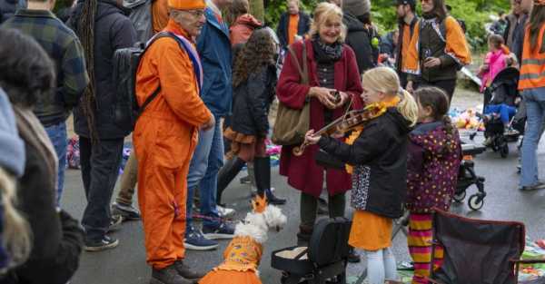 Revellers dress in orange to celebrate Dutch king’s birthday