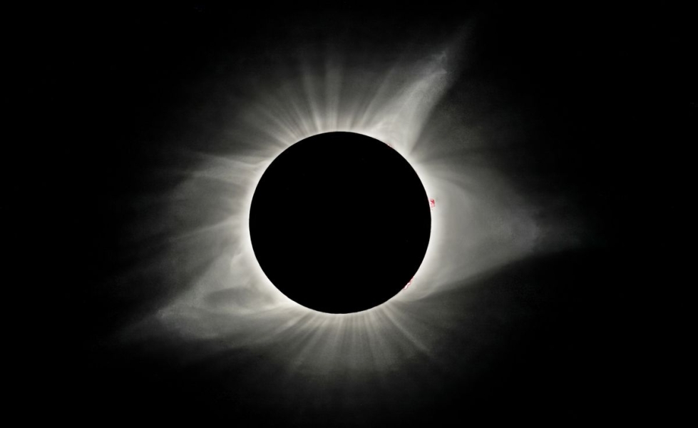 An image from Madras, Oregon, on August 21, 2017, shows the sun obscured by the moon in a solar eclipse. Hanging in a black sky is a black orb, outlined by a glowing, misty white corona.