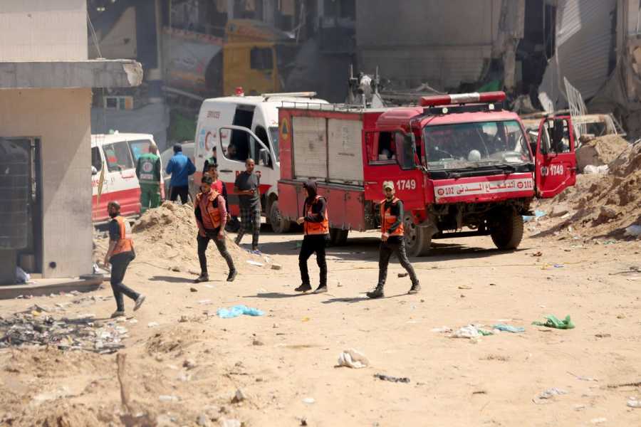Emergency vehicles and workers outside a bombed hospital.