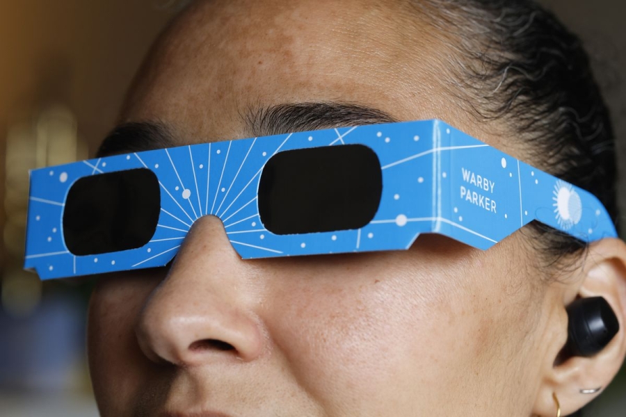 In this photo illustration, a woman models eclipse glasses from Warby Parker on April 1, 2024 in New York City.