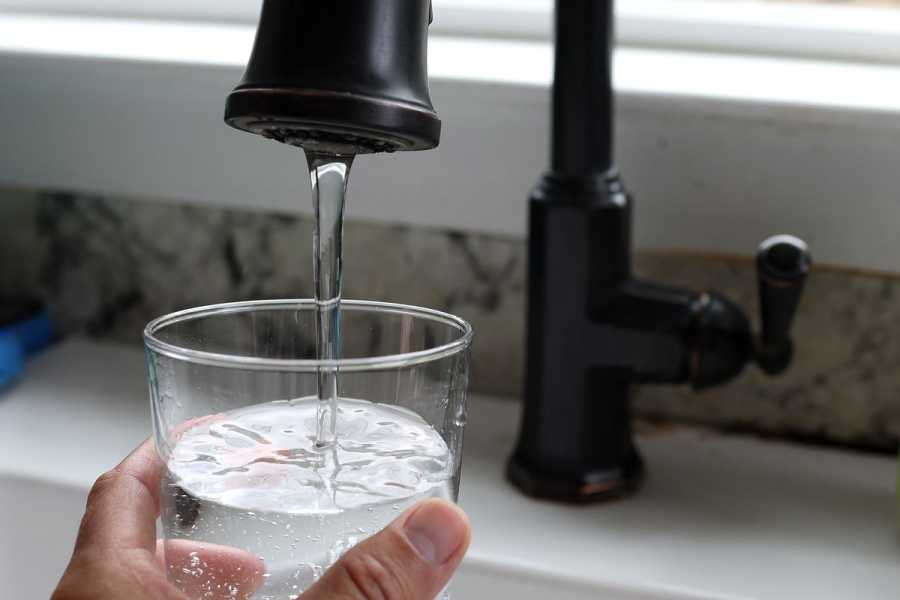 In this photo illustration, water from a tap fills a glass on July 6, 2023, in San Anselmo, California.