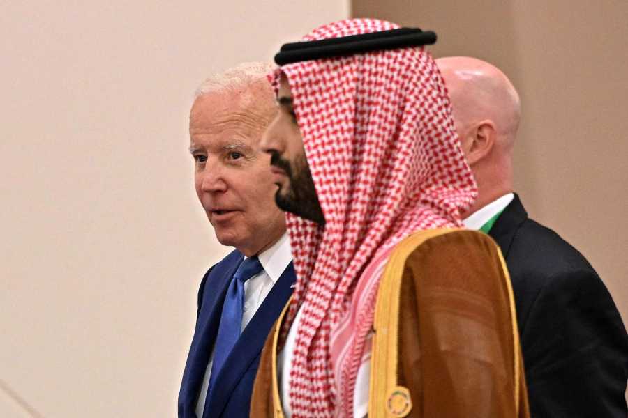 Biden walking behind Crown Prince Mohammed bin Salman as the two enter a room.