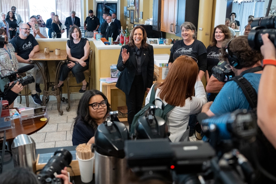 Harris smiling in a crowded coffee shop.