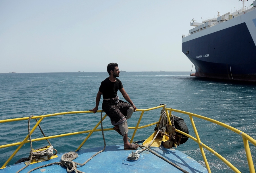 A fighter of the Houthi group looks at the Galaxy Leader cargo ship as he guards it, on the Red Sea coast off Hudaydah, Yemen on May 12, 2024.