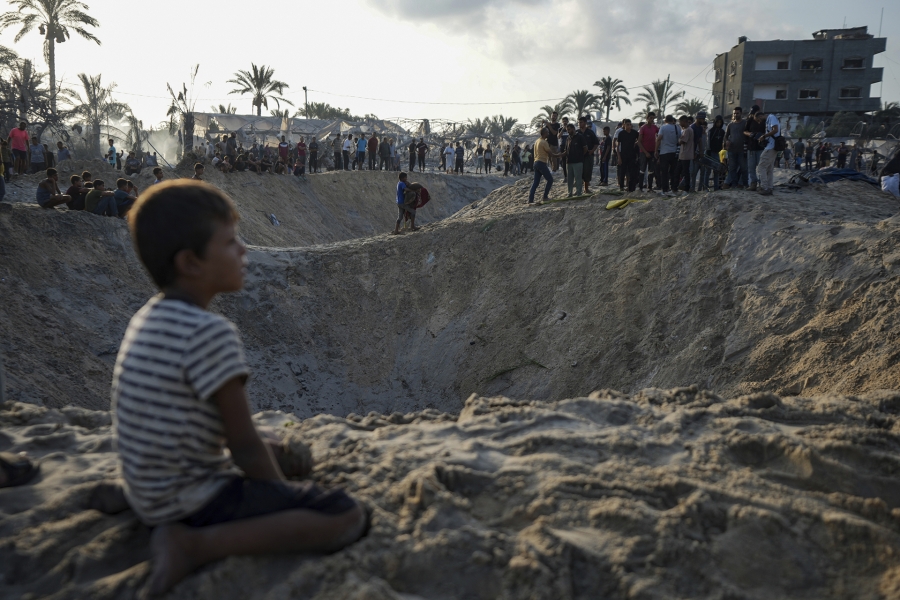 Palestinians look at the destruction after an Israeli airstrike on a crowded tent camp housing Palestinians displaced by the war in Muwasi, Gaza Strip, on September 10, 2024.