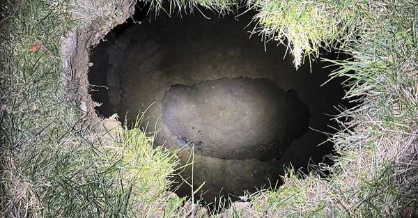 Search extends into night for US woman who may have fallen into sinkhole