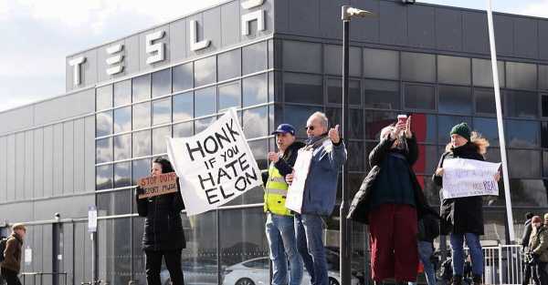 Protesters gather outside Tesla dealership in London, call for boycott