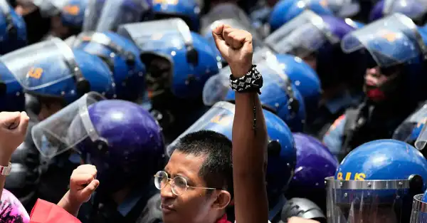 Thousands of people around the world march to celebrate May Day and protest tariffs