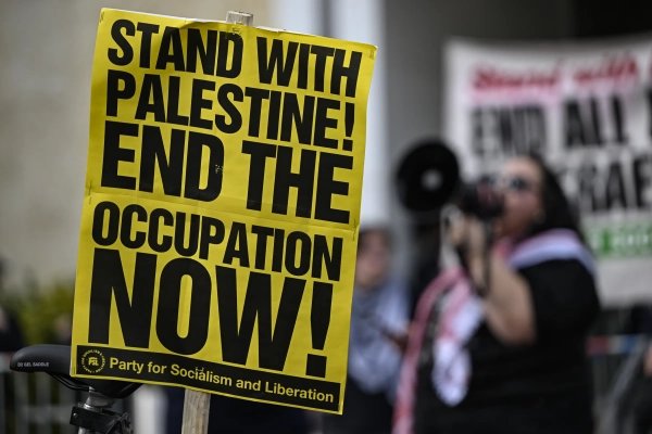 A group of demonstrators stage a protest outside AIPAC’s headquarters in Washington, DC.