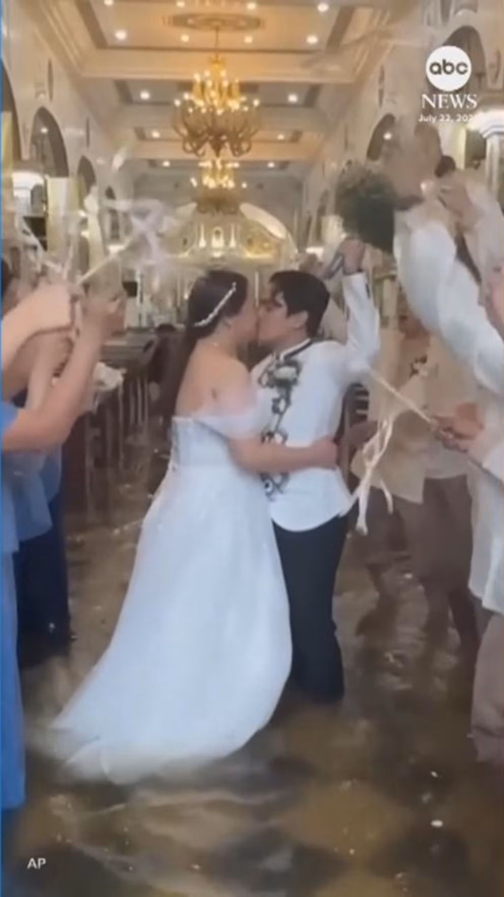 Video: Couple walks through flooded aisle on their wedding day in Philippines
