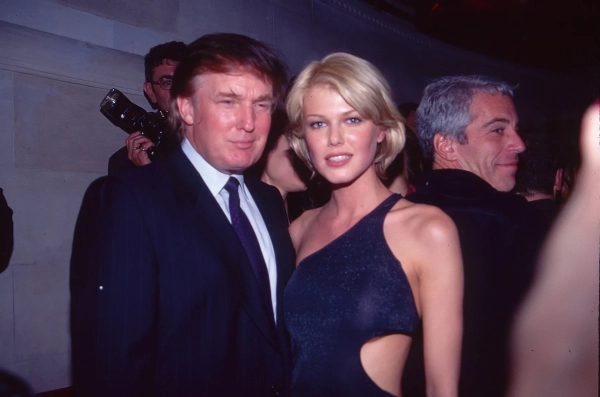 Trump poses for a photo with Seynhaeve, Epstein is behind them