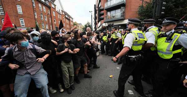 Police arrest protesters in London during counter protests outside refugee hotel