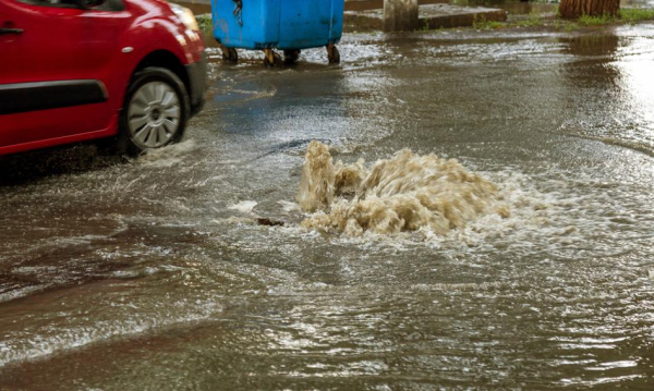After heavy rains, water flows down city streets. Prof. Rouba: Lawns located lower than the road and front gardens would absorb the water.